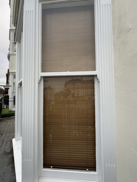 Restored sash window with detailed woodwork.